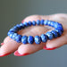 Blue beaded Lapis bracelet on a hand with a blurred background