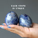 two denim lapis eggs in hand