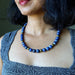 Close-up of a person wearing a Lapis Lazuli necklace 