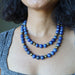 Person wearing a blue Lapis Lazuli necklace 
