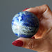 denim lapis sphere in hand