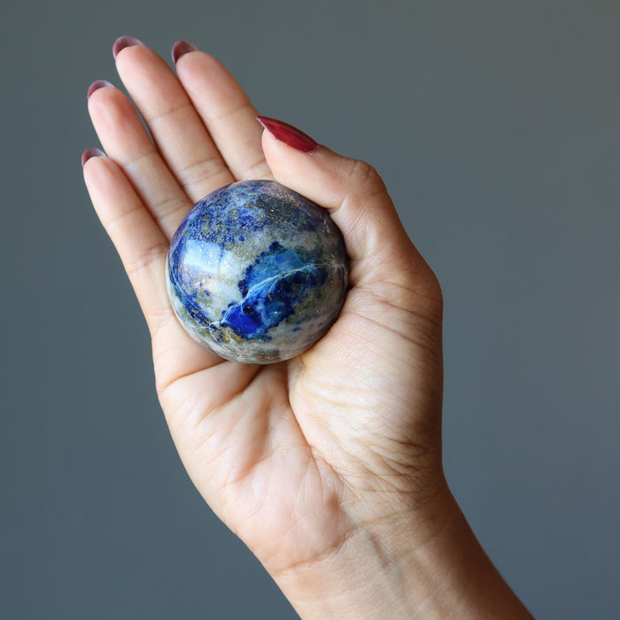 denim lapis sphere in palm