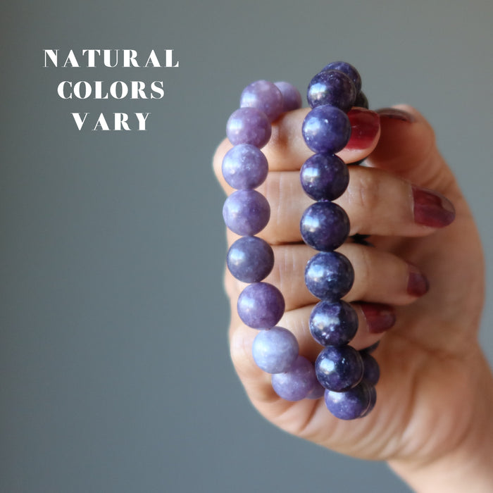 dark lepidolite bracelets on hands