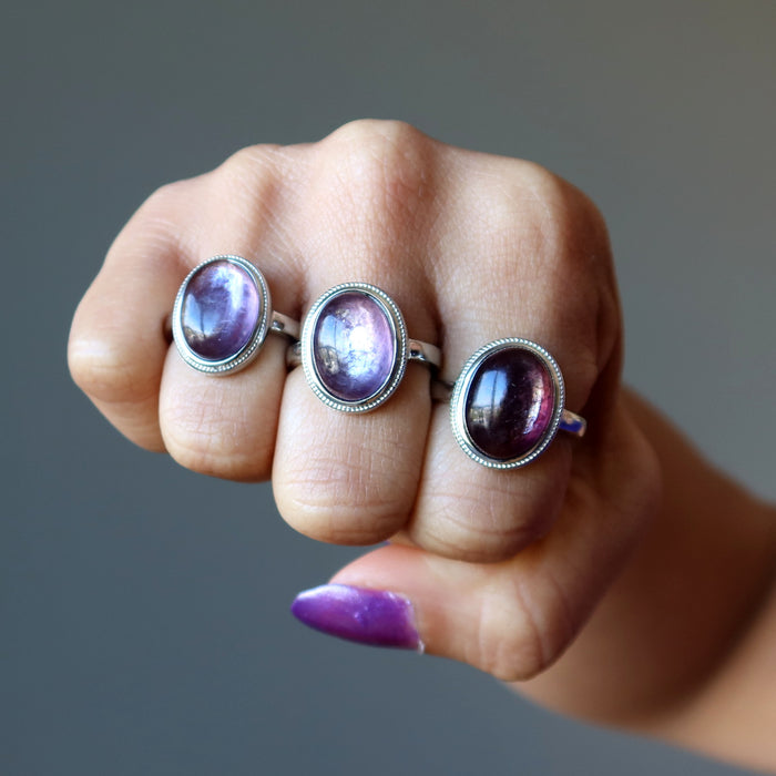 purple lepidolite oval rings on fingers