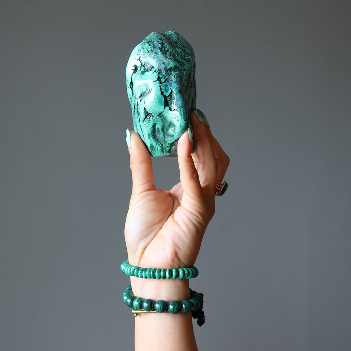 hand wearing and holding malachite