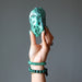 hand wearing and holding malachite