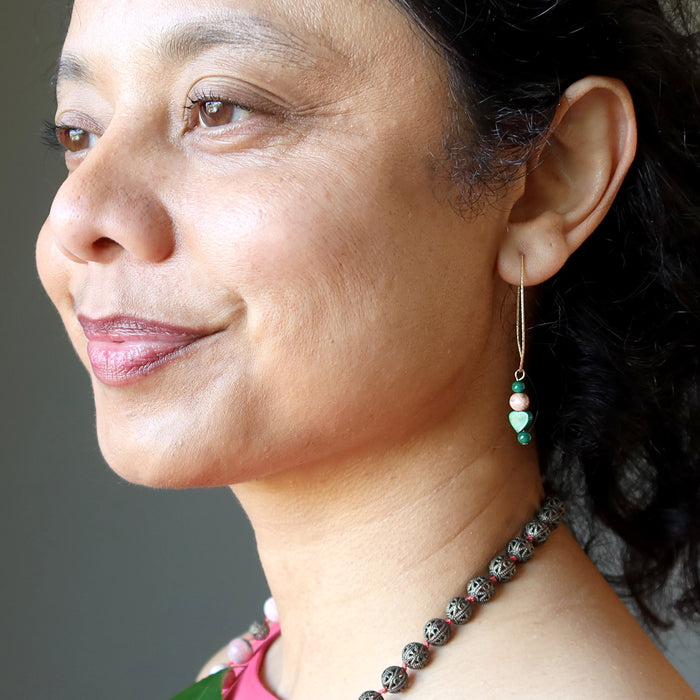 woman wearing malachite and rhodochrosite gold earrings
