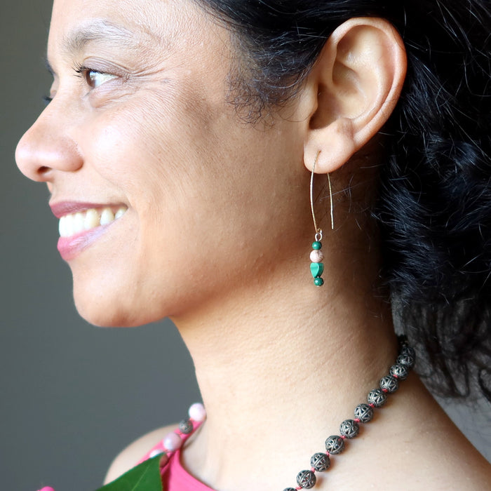 woman wearing malachite and rhodochrosite gold earrings
