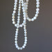 White Moonstone Necklaces on a dark gray background