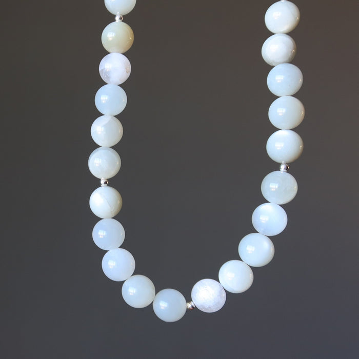 White Moonstone Necklace with white beads on a dark background