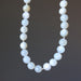 White Moonstone Necklace with white beads on a dark background