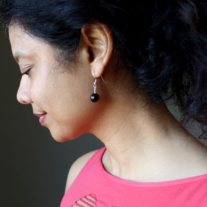 woman wearing faceted sheen obsidian earrings