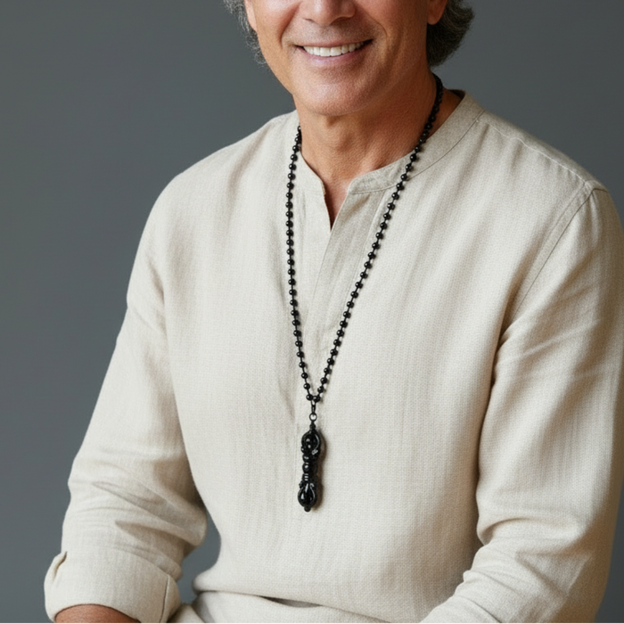 man wearing dorje necklace