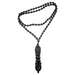 Black beaded necklace with a decorative pendant on a white background