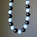 Necklace with alternating black obsidian and light blue angelite beads