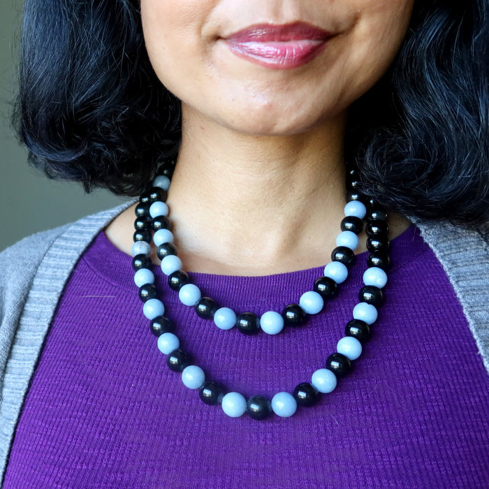 woman wearing two Necklaces with alternating black obsidian and light blue angelite beads
