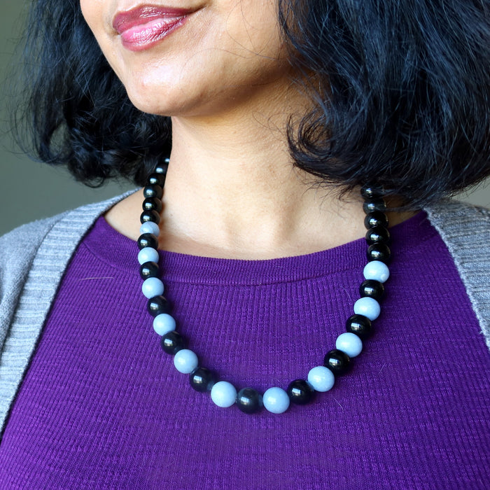 woman wearing Necklace with alternating black obsidian and light blue angelite beads