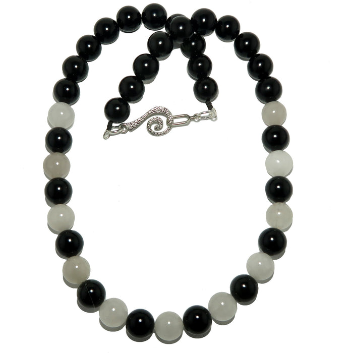 Rainbow Obsidian Snow Quartz necklace with alternating black and white beads on a white background