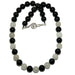 Rainbow Obsidian Snow Quartz necklace with alternating black and white beads on a white background