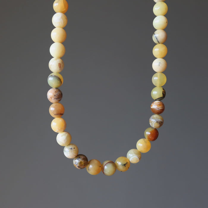 Opal necklace with multicolored beads on a gray background