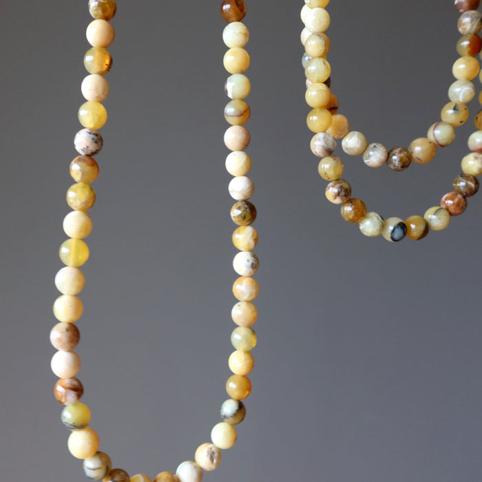 Close-up of a beaded Opal necklace with multicolored beads on a gray background
