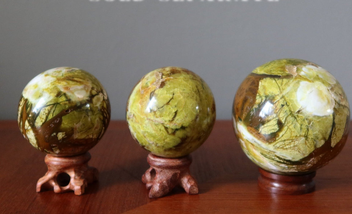 three opal spheres on display stands