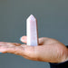 pink opal crystal tower wand in palm
