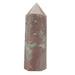 A polished pink opal crystal with white inclusions, shaped like a tower, on a plain background.