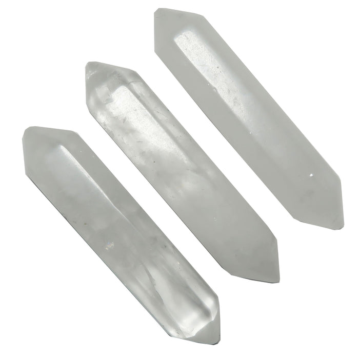 Three clear quartz doubleterminated crystals on a white background