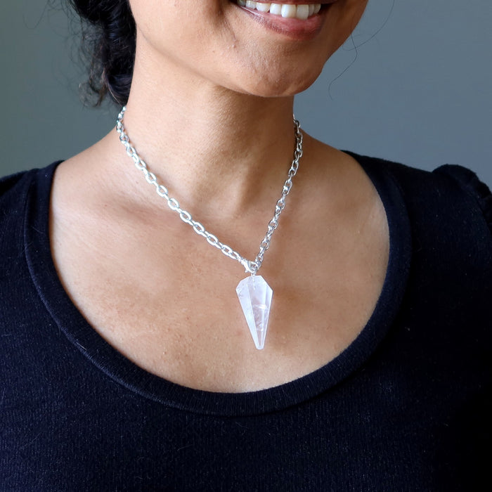 clear quartz pendulum necklace on woman's neck