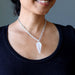 clear quartz pendulum necklace on woman's neck