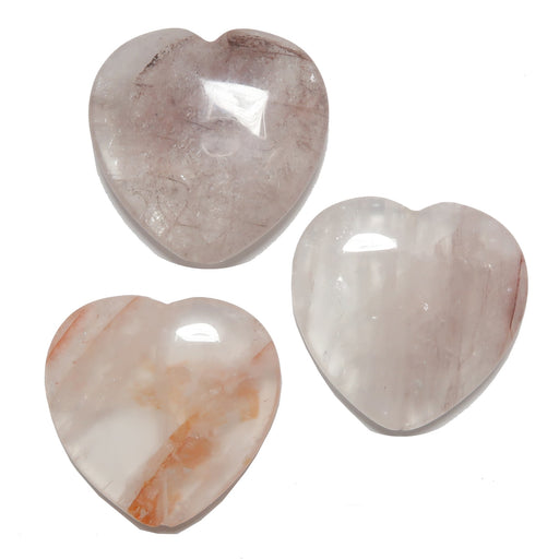 Three heart-shaped Quartz stones on a white background