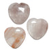 Three heart-shaped Quartz stones on a white background