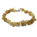 Bracelet with yellow Rutilated Quartz chips on a white background