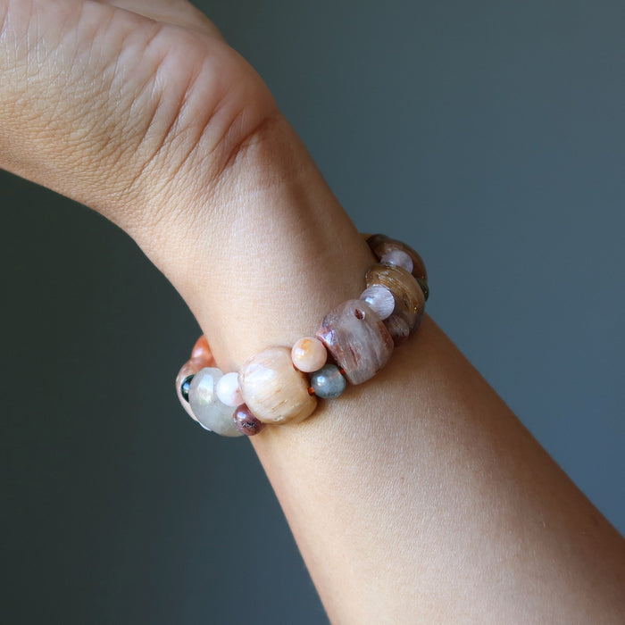 Beaded bracelet on a wrist against a neutral background