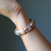 Beaded bracelet on a wrist against a neutral background