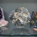 Collection of various crystals and minerals on a reflective surface