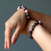 rhodonite bracelet on wrists