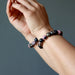 two rhodonite bracelets on wrists