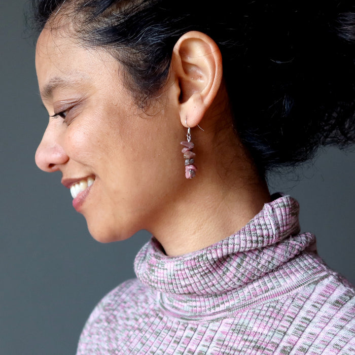 woman wearing rhodonite earrings