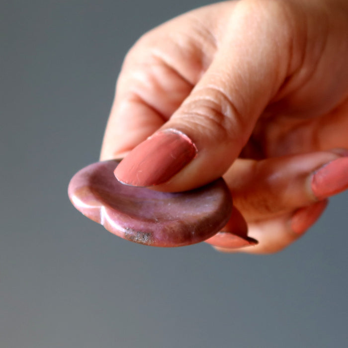Holding Pink Rhodonite Worry Stone 