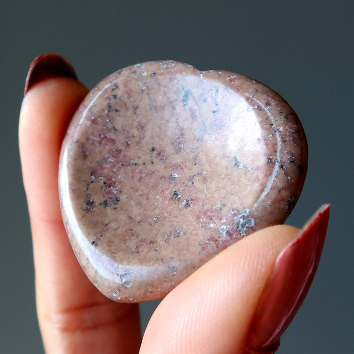 Holding Pink Rhodonite Worry Stone 