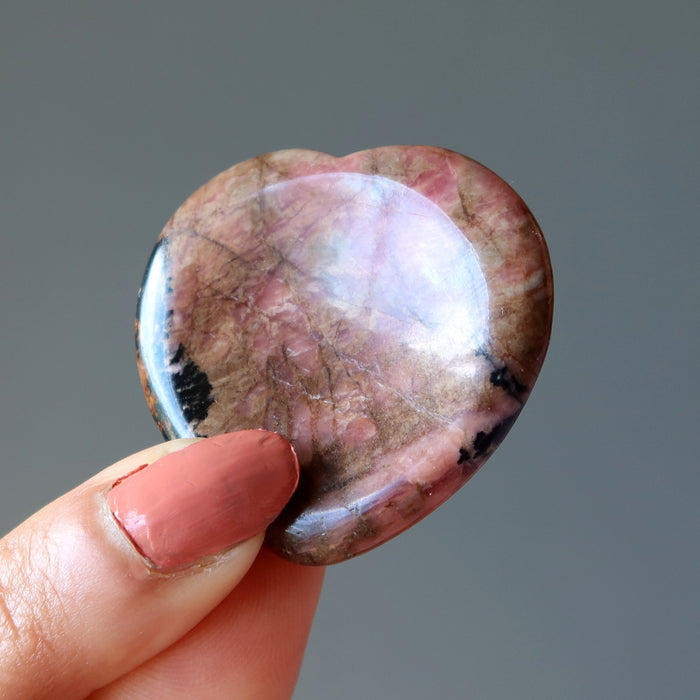 Holding Pink Rhodonite Worry Stone 