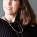 woman wearing beaded rhodonite necklace
