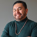 man wearing beaded rhodonite necklace