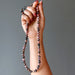 beaded rhodonite necklace in hand