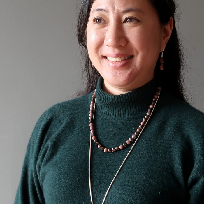 woman wearing beaded rhodonite necklace