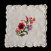 Hungarian Kalocsa Embroidered floral design on a white fabric square with scalloped edge.