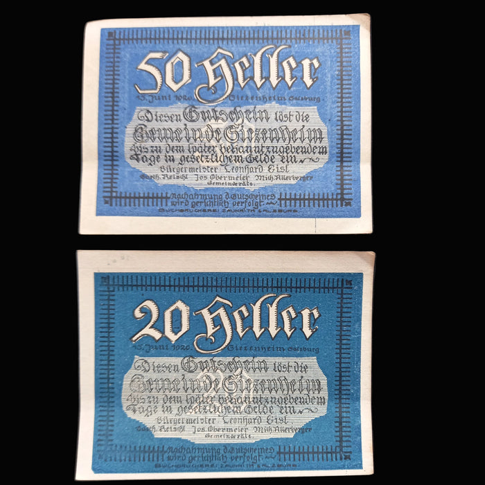 Two vintage German banknotes with blue and white design on a dark background