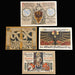 Collection of vintage pfennig german notgeld banknotes with intricate designs and text on a dark fabric background.